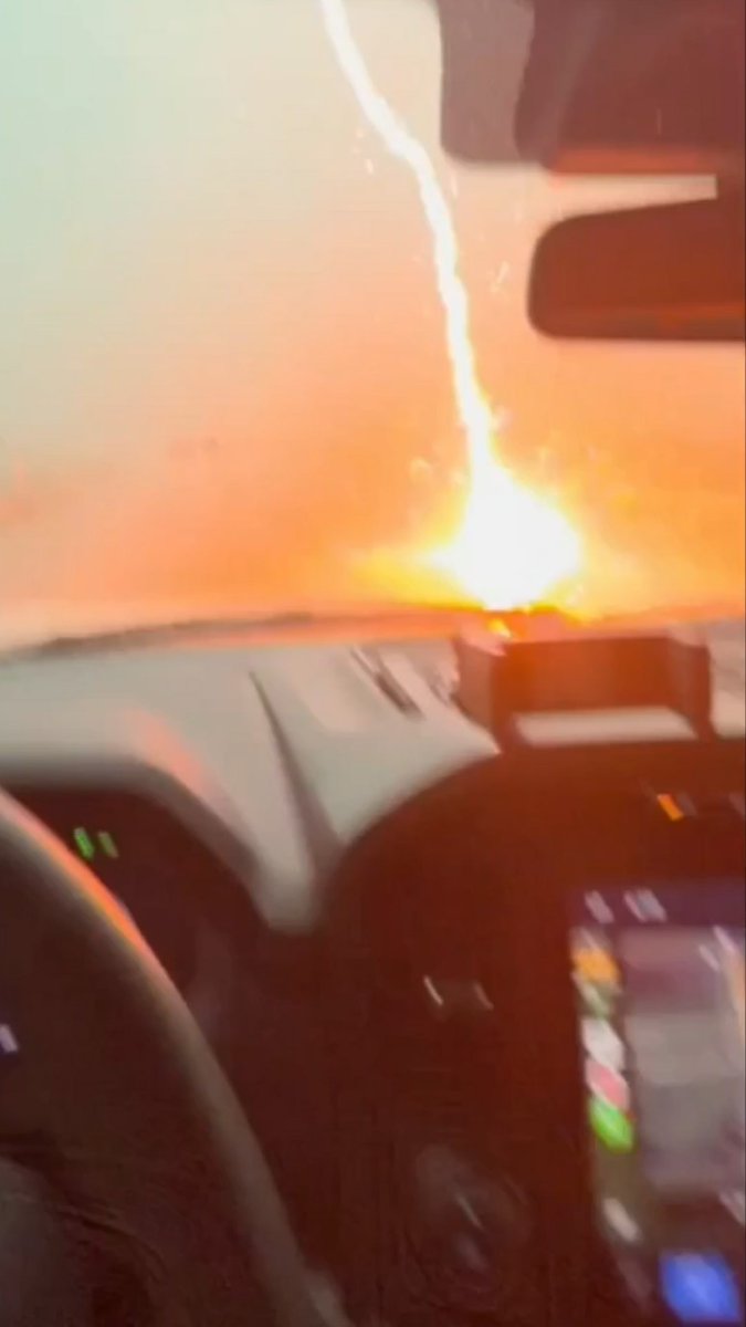 'OH MY GOSH!': Driver captures the "insane" moment a lightning bolt strikes the hood of his truck during a torrential Texas storm.