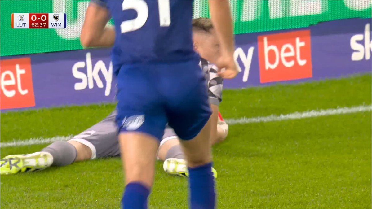 Nathan Bishop denies a 25‑yard effort with a vital save for AFC Wimbledon 🧤
