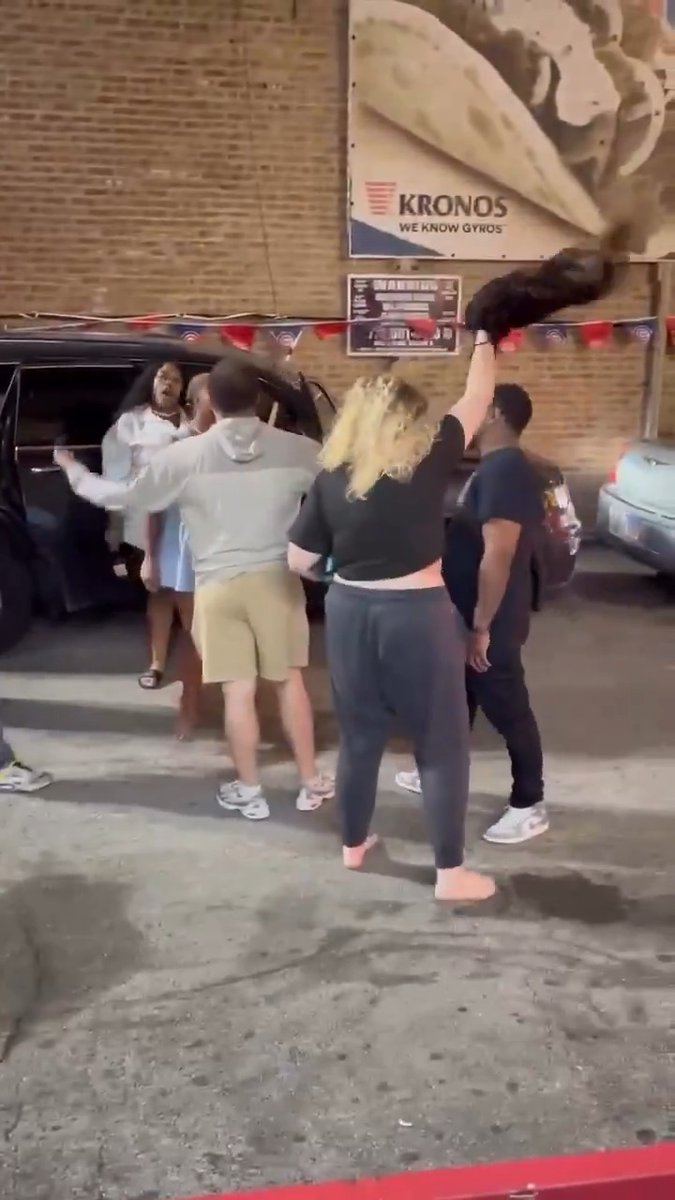 Let's check in on the "nice area" of Chicago and see how it's going. I was expecting a shooting but instead, we have a fight with wig twirling - I'll allow it... #CityLife #WrigleyvilleDogs #chicago #wig