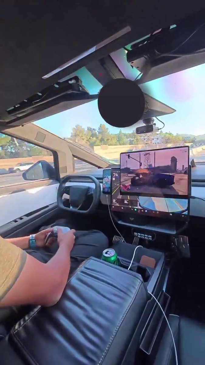 Bro playing Car Video Game whilst his Tesla Car drives itself. The future is already here.