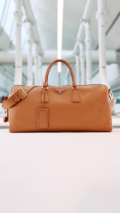 Rooted in travel craftsmanship since 1913, Prada’s legacy endures. The new Duffel Bag expresses functional design and artisanal expertise - soft deerskin-effect leather, practical details, and a form that speaks of modern movement and timeless intent. Discover more at: #Prada