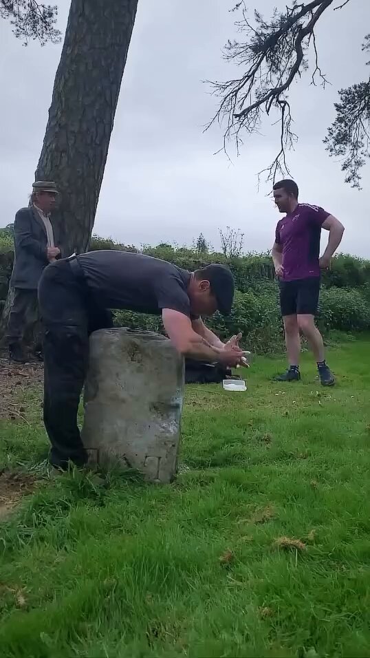 Picking up a heavy stone while the boys hype you up