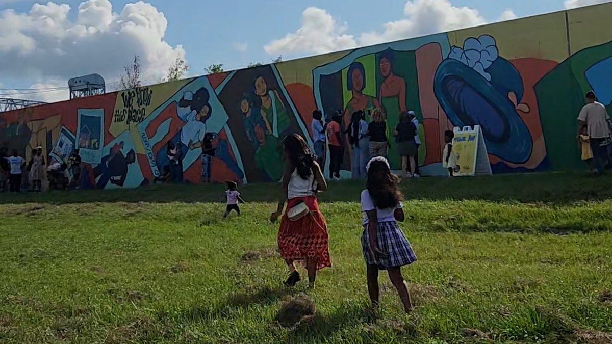 Teens at the Eternal Seeds youth art program in New Orleans painted a mural at lower 9th ward levee breach site to commemorate 20 years since Hurricane Katrina.
