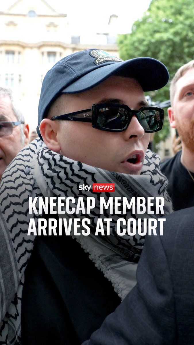 Kneecap member Liam O'Hanna arrives at Westminster Magistrates Court to face terror charges after being accused of displaying a flag in support of Hezbollah at a gig last year Read more: