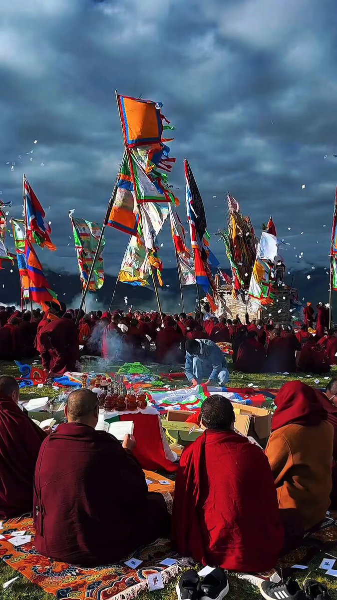 Tibetan monks honoring the gods of the mountains and grasslands Cards with written prayers are scattered into the wind and carried to the gods of the mountains and steppe. libations of food and alcohol are also made