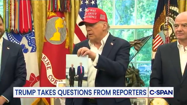 President Trump holds up photo sent by Russian President Vladimir Putin: "I'm going to sign this for him ... That's a man named Vladimir Putin who I believe will be coming (to 2026 FIFA World Cup) depending on what happens."
