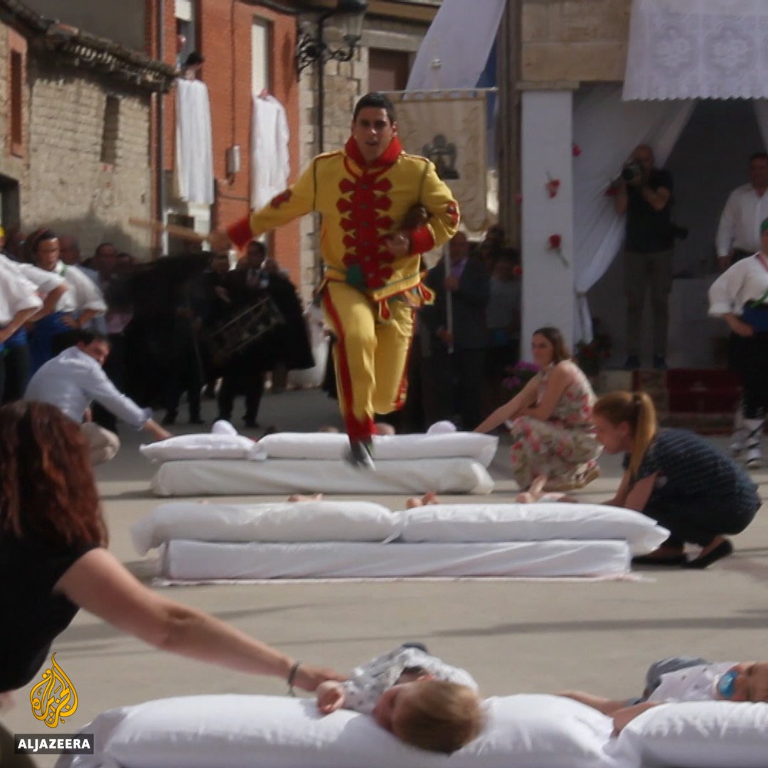 8 . Men wearing devil costumes jump over babies lying in rows during this old Spanish religious festival that began in the 1600s.