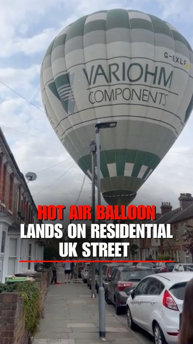 Hot air balloon descends in the middle of a residential street in Bedford, UK.