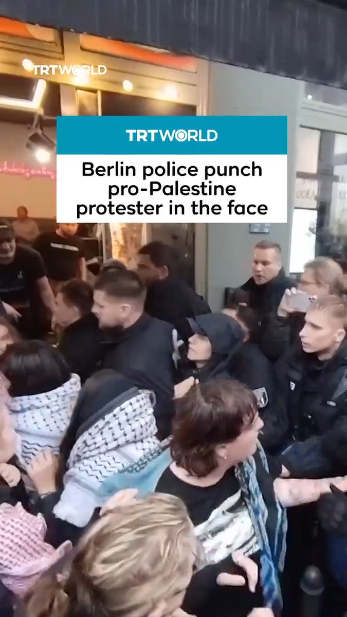 Footage shows Berlin police violently punch a peaceful protester in the face multiple times, causing her to bleed before taking her into custody