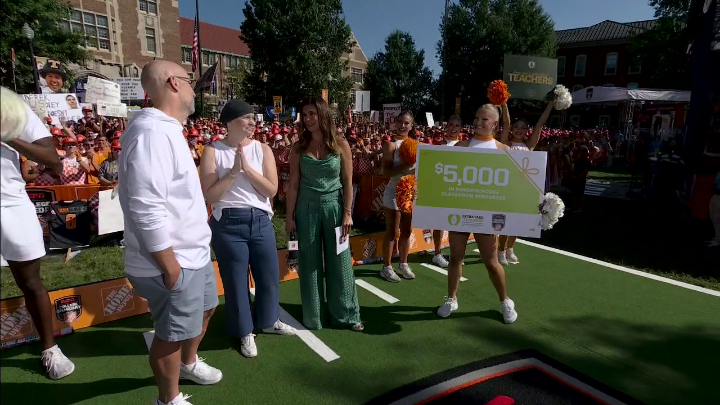 College football fans Sarah and Josh Holmon have been married for over 20 years. When Sarah was diagnosed with breast cancer this May, Josh, a teacher, decorated his classroom in a special way. Today, we are thrilled to welcome Sarah and Josh to College GameDay. And not only that, but the College Football Playoff Foundation is inviting them both to the CFP national championship and donating $5k to Josh's school ❤️ Jen Lada