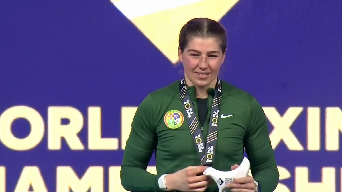 Aoife O'Rourke stands atop the podium to receive her gold medal, as Amhrán na bhFiann is played at the World Boxing Championships in Liverpool.