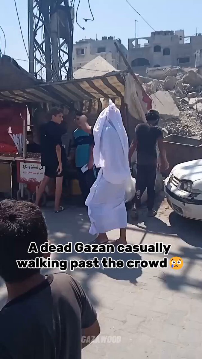 A dead Gazan casually walking past the crowd 😢😢😢
