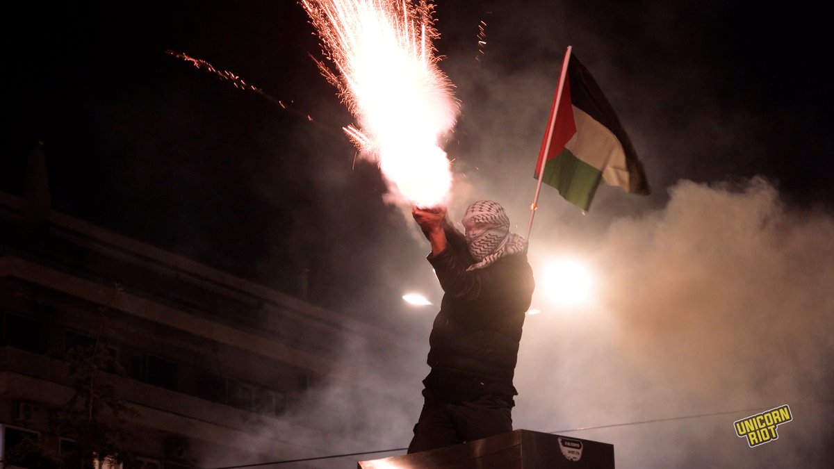 NEW: Demonstrators Protest in Front of the Israeli Embassy in Greece, Police Violently Attack Crowd Around 5,000 demonstrators marched through Athens’ city center to the Israeli Embassy in solidarity with the Palestinian people on Oct. 7, 2025. Dozens of riot police with helmets and gas masks stood in front of several large police busses that formed a barricade on the street, blocking the demonstrators’ access to the embassy. Amid waving Palestinian flags and fireworks being shot off towards the Israeli Embassy, some of the chants were “viva Palestina,” “free Gaza,” “free Palestine,” “we are all Palestinian,” “fuck you Israel,” and “death to the IDF.” Police attacked the crowd, using flashbang grenades, pepper spray, and tear gas as the gathering was nearing its end and the various blocs of demonstrators had already begun to disperse. The pretext for the attack was two Molotov cocktails thrown from the anarchist bloc. The police carried out dozens of indiscriminate arrests and caused serious injuries to demonstrators. According to eyewitnesses, protesters’ limbs were broken and several were injured in the head.