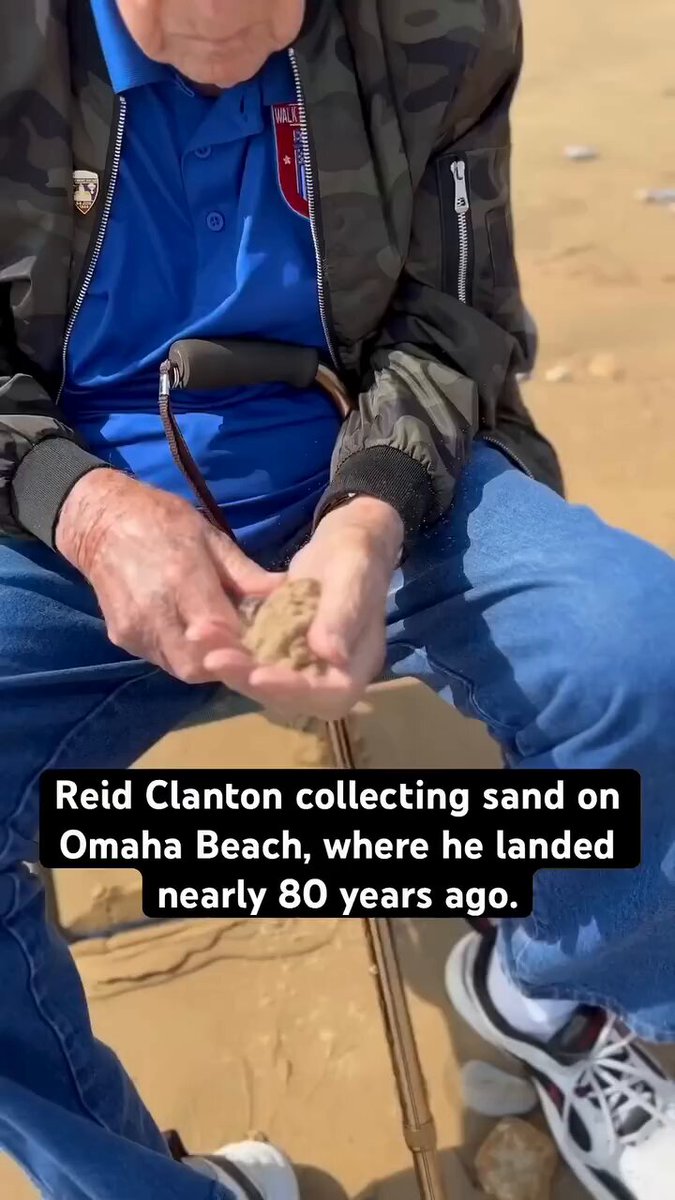 Reid Clanton collecting sand on Omaha Beach, where he landed nearly 80 years ago.
