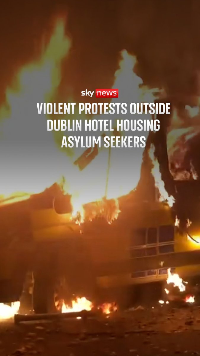 A police van has been set on fire, and bottles have been thrown at police as protesters gather at a hotel housing asylum seekers in Dublin.