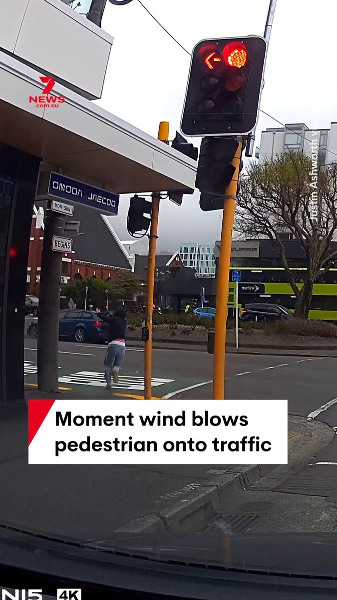 Dashcam footage has captured the moment a strong gust of wind appears to blow over a pedestrian and send them stumbling and tumbling onto the road and into traffic in Wellington. Intense winds have battered parts of New Zealand. #wind #wildweather #dashcam #Wellington #NewZealand