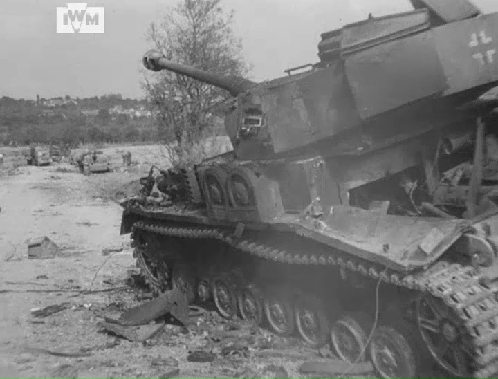A German road convoy destroyed by RAF fighter-bombers is found on a country road east of the Falaise-Argentan highway, 20 August 1944. Film: IWM A70 130-5