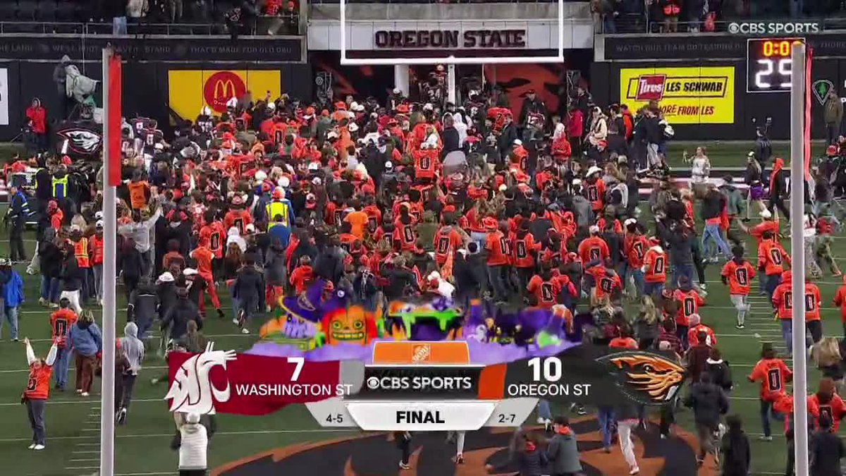 Oregon State fans are storming the field after defeating Washington State.