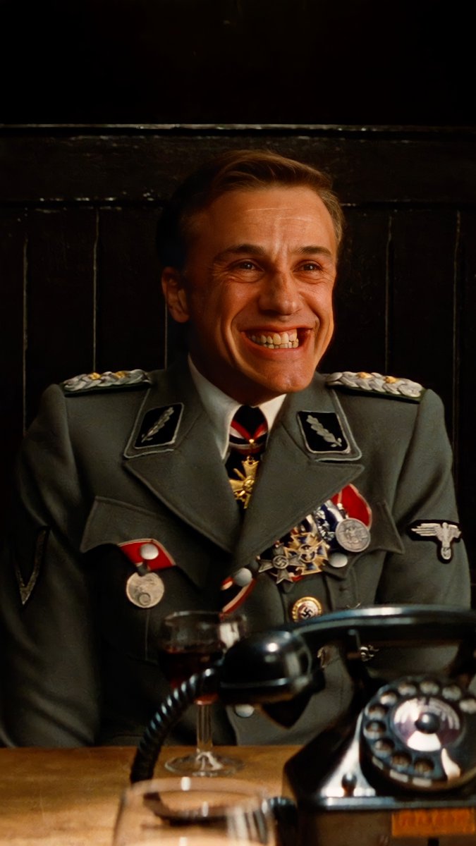 Christoph Waltz as Hans Landa in Inglourious Basterds (2009) is the kind of villain you hate yourself for enjoying. Every line, every smirk feels like a performance within a performance. Tarantino called him “a gift from God.”