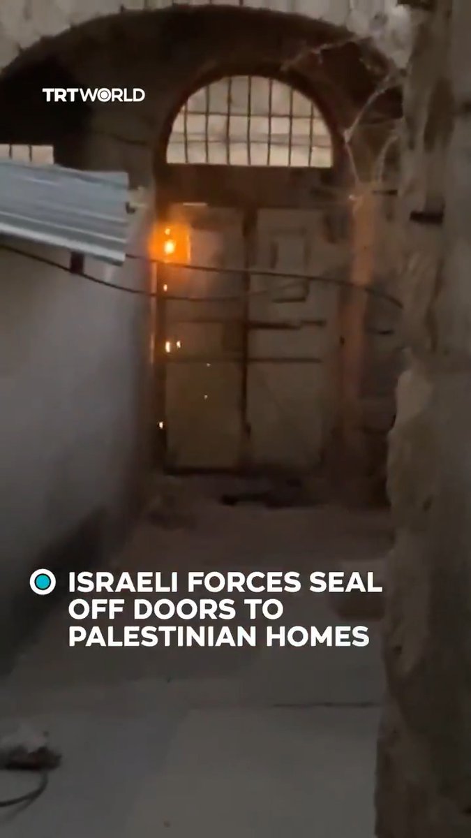 Israeli occupation forces use welding tools to seal the doors of several Palestinian homes, preventing residents from entering or leaving, in Hebron, in the occupied West Bank