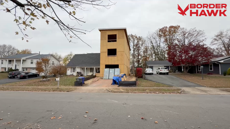 EXCLUSIVE: Virginia Homeowner Defends His Controversial Build Project A Virginia resident is telling his side of the story after a large addition being built on his property received significant attention. Mike, a Vietnamese immigrant who says he has lived in his Fairfax County home for 20 years, granted Border Hawk a tour of his construction project, which has sparked local and national backlash. “As soon as it got up to the third floor, I noticed a lot of people going by with their cars,” Mike explained. “It’s something that our family decided to do so that we can have space for the kids and the family.” Mike says people began harassing him, taking pictures and videos of his home, and even berating his young children in the yard, so he installed security cameras. Interest in Mike’s build increased after a neighbor posted about it in a local Facebook group, he says. His neighbors also expressed concerns about the project in recent interviews with Fox 5. “It feels like it’s not real. When you see it… it’s shocking,” Katie Dash told the outlet. “We’re all just concerned that if it could happen to her [Mike’s immediate neighbor, Courtney Leonard], it could happen to any of us. I’m still confused how it was approved.” Leonard, who lives in the shadow of the new structure, says she has been waiting for clarity on the issue. “I love this neighborhood, and the people in it have been so helpful. It just feels like there’s nowhere else to go,” she said. Mike asserts he followed all regulations and his contractor built in strict adherence to plans approved by Fairfax County. However, the build has been suspended due to a corner of the structure encroaching upon setbacks. “The measurement of the building is correct as planned,” Mike explained. “I’m not sure what zoning did.” “It’s the plan that is approved and it’s built exactly per plan, but now it’s come out like that.” Mike says it is unclear where the mistake was made, but he hopes to rectify the matter via a variance request. The addition’s architectural design — which has been called a ‘residential apartment complex’ — is also raising eyebrows, but Mike hopes its modern style will blend better with the original structure if he’s able to eventually re-pitch his existing roof. “The main thing that we want is to have the best for our family,” Mike said. “All I am doing here is provide the best thing for my family, and not affect anybody else.” “We all want the best for our kids, for our family, but at the end of the day, we want to live with our neighbors. We see our neighbors more than our relatives. We want to have the best relationship that we can with our neighbor.” “I feel bad that I have to go through this and my neighbor sees my family in a different way, but that’s just how it is right now,” he concluded. Springfield District Supervisor Pat Herrity says the structure “clearly does not belong in our suburban neighborhoods” and plans to propose changes to zoning ordinances at a board meeting this week. Support our work: