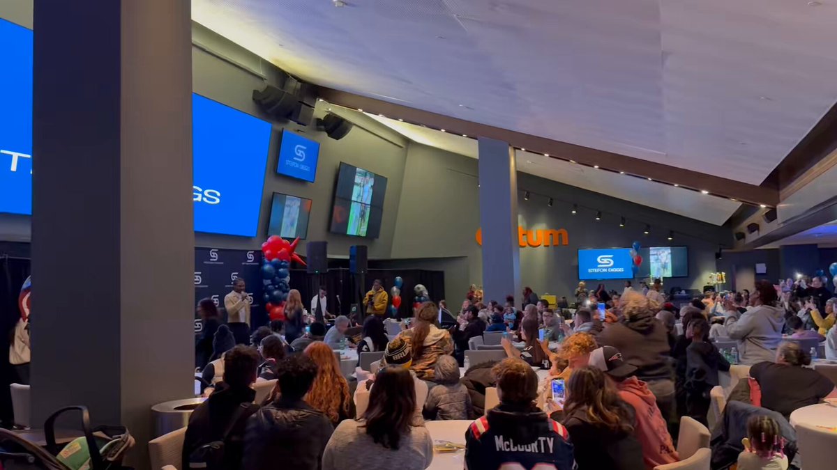 Stefon Diggs welcomes the crowd and explains the purpose of the night, before visiting the face-painting table and handing out holiday bags.