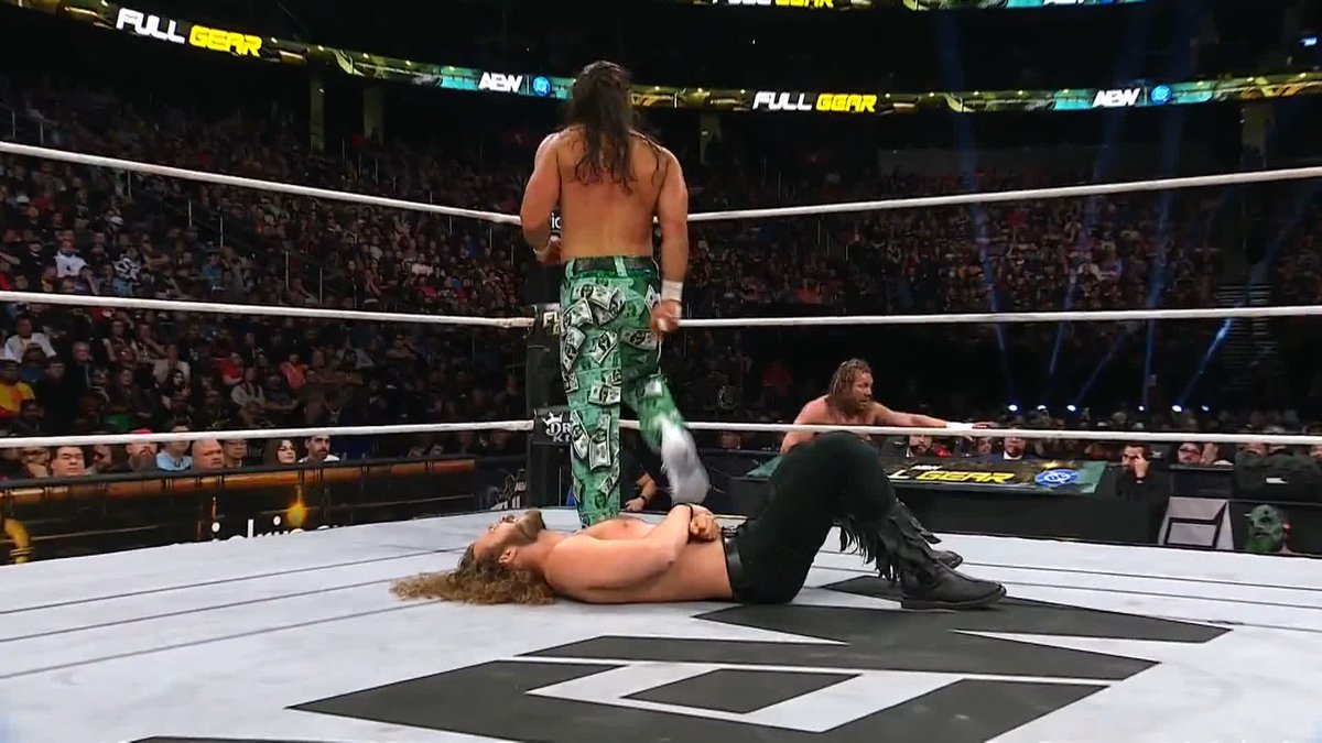 Matt Jackson with a smooth fake out as he surprises Kenny Omega with a big Moonsault