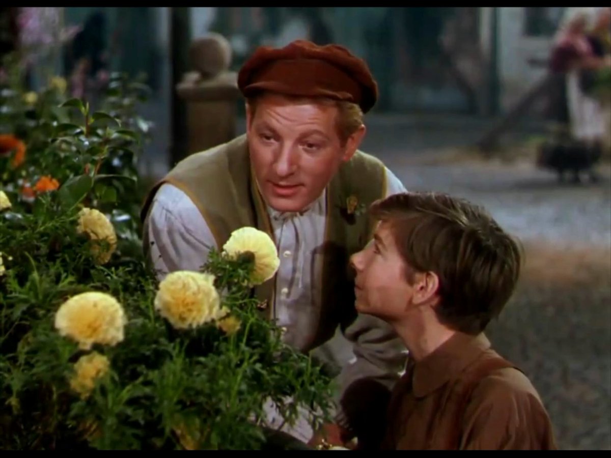 Danny Kaye singing “The Inch Worm” to Joseph Walsh as Peter in director Charles Vidor's “Hans Christian Andersen” (1952). While this film directly adapts some of Andersen's best-known stories ― “The Emperor's New Clothes”, “Thumbelina”, and “The Ugly Duckling” as songs; “The Little Mermaid” as a fantasy ballet sequence ― it also subtly alludes to others. For instance, when Hans and his ward Peter first enter the Great Square of Copenhagen, they pass a woman selling matches. This is a hint to “The Little Match Girl”. Also, a major subplot of the film is Hans' unrequited love for the beautiful yet detached ballerina Doro. This is a homage to “The Steadfast Tin Soldier”, where a disabled toy soldier has a doomed romance with a ballerina doll.