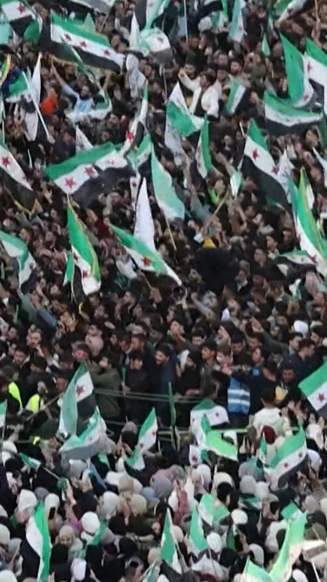 Tens of thousands of Syrians took to the streets of Hama to mark the first anniversary of the ouster of Syria's longtime ruler, Bashar al-Assad.