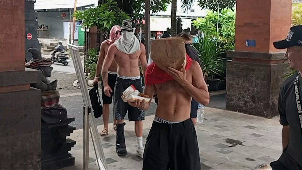 A group of Australian men has been dragged before Bali immigration officers. They are under investigation after being arrested alongside adult content creator Bonnie Blue. The tourists have been released, but officials still have their passports. James Carmody