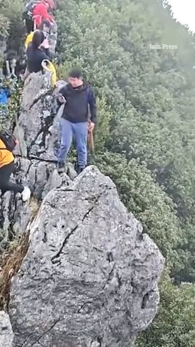 Terrifying moment tourist falls off cliff while taking selfie
