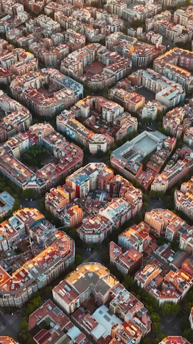Eixample is a district in Barcelona known for its long, straight streets, wide avenues and square blocks with chamfered corners. Hannah Fry explores this carefully-designed neighborhood to uncover the history behind its unique layout. Watch The Infinite Explorer