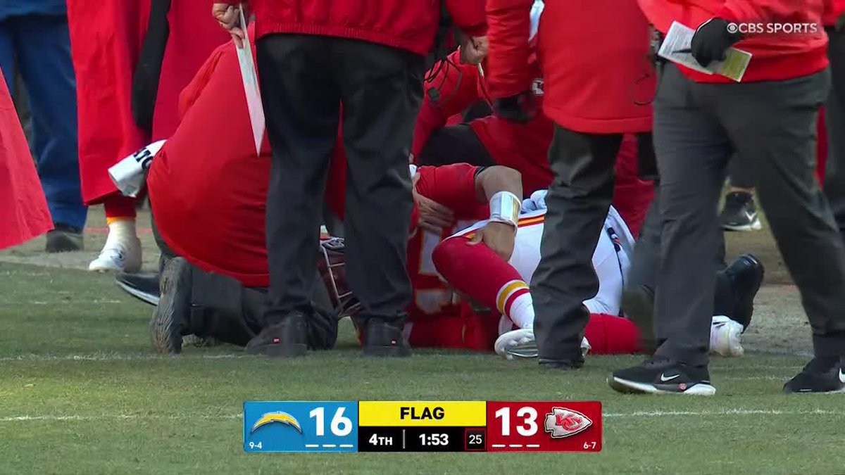 Mahomes is down and holding his left knee in pain