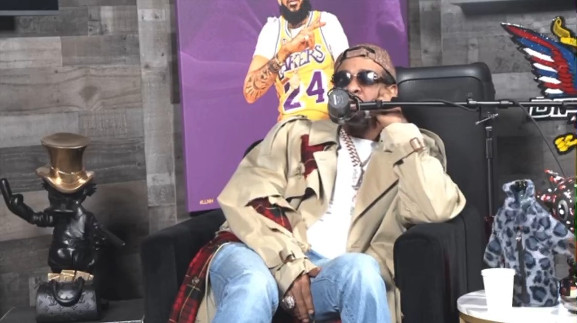 50 Cent goes in on Maino, Jim Jones, Fabolous and Dave East for having a convo about unauthorized docs on their podcast, Let’s Rap About It. On a Dec. 11 podcast, Dave East asked the question: "Is it acceptable for someone to create a documentary about you without your approval? How would you feel if it happened to you?" Jim Jones was the first to respond. "It's like, definitely not acceptable. It's facetious and petty, right?" Then Maino chimed in. "It's like somebody putting out your sex tape." On Monday (Dec. 15), Fif calls them squatters for allegedly failing to pay the rent for the podcast space they use while Maino fires back and asks what has 50’s “G-Unit G-String in a Bunch.” Maino insists it was a general conversation about unauthorized documentaries, but he’s ready to fire back when he sees his photo in posts on social media. Fif also claims he will be buying the Let's Rap About It podcast space.