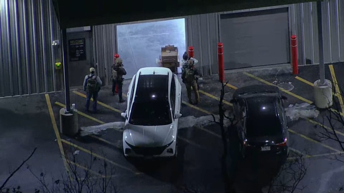 Police were visible outside a building in Salem, New Hampshire. The activity was believed to be related to the Brown University shooting. Sources told NBC 10 earlier that the person of interest had been identified.
