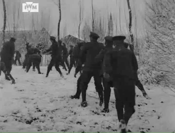 Soldiers participate in a snowball fight in Flanders on the Western Front, January 1918. Film: IWM IWM 1061-09c