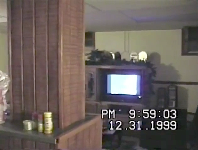 Guy shows off his new $5,000 TV to friends at a 2000 New Year's Eve party