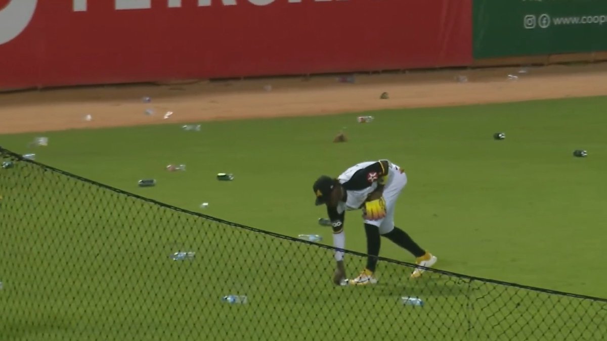 Fans throw trash on the field because obstruction was called on the catcher, a breakdown