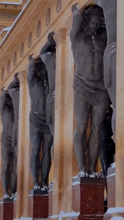 These are the Atlantes of the Hermitage, 5 m tall, carved from single blocks of grey granite by Alexander Terebenev in the 1840s. St. Petersburg, Russia
