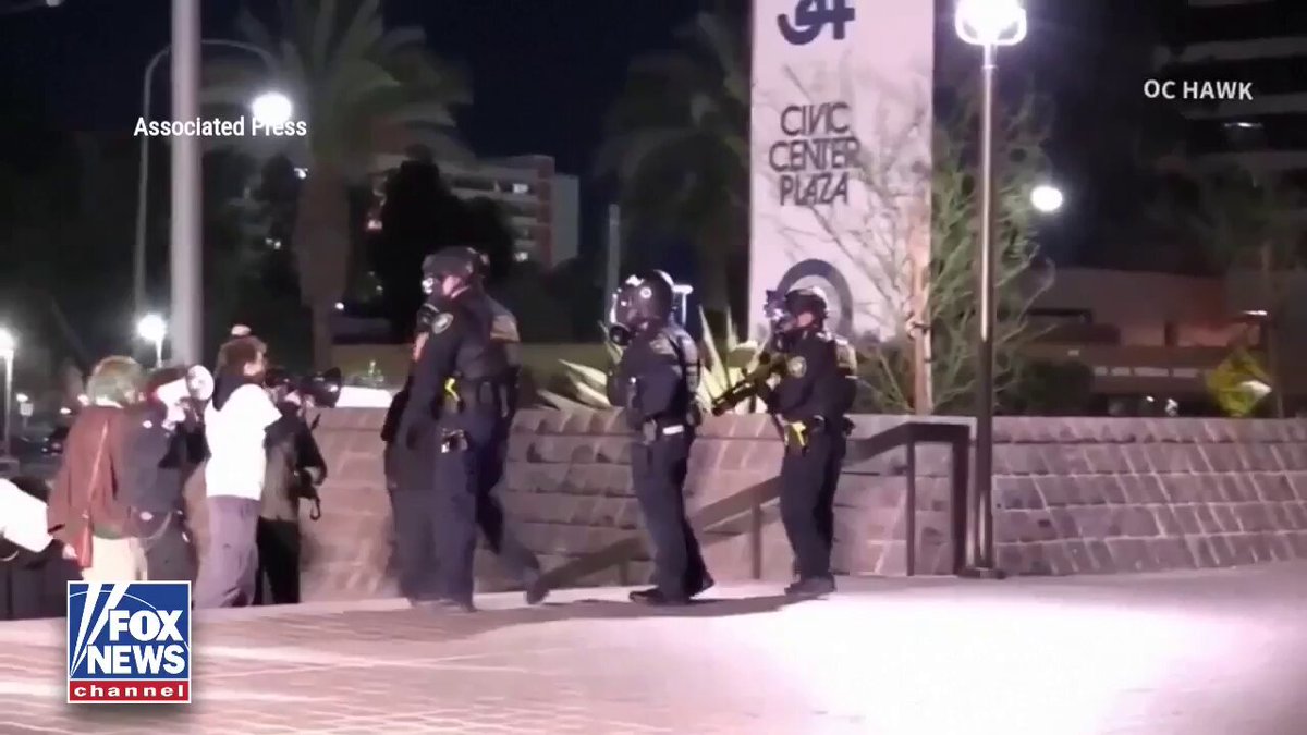COLD FRONT: Law enforcement detain a man with a bullhorn in a struggle outside a federal building in California.