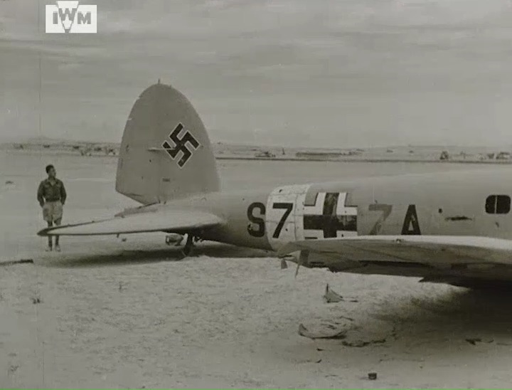 British troops examine a downed Heinkel He 111 during the advance to Mersa Matruh, Egypt, 1942. Film: IWM AYY 272/27 <1/2>