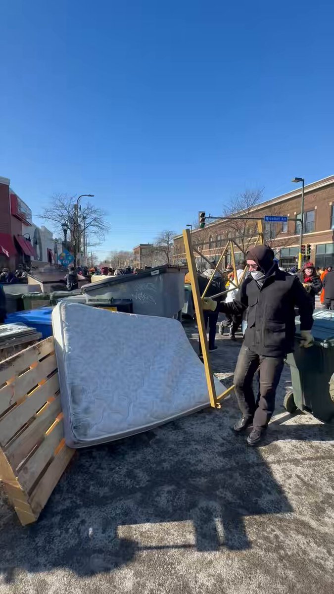 Protesters are erecting barricades around Nicolette Avenue and 26th St now that authorities have left the area.