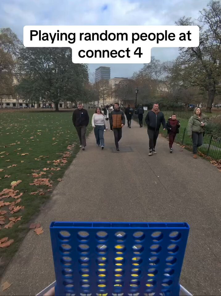 He asks random people he finds walking around to play a quick game of connect 4 without saying a word