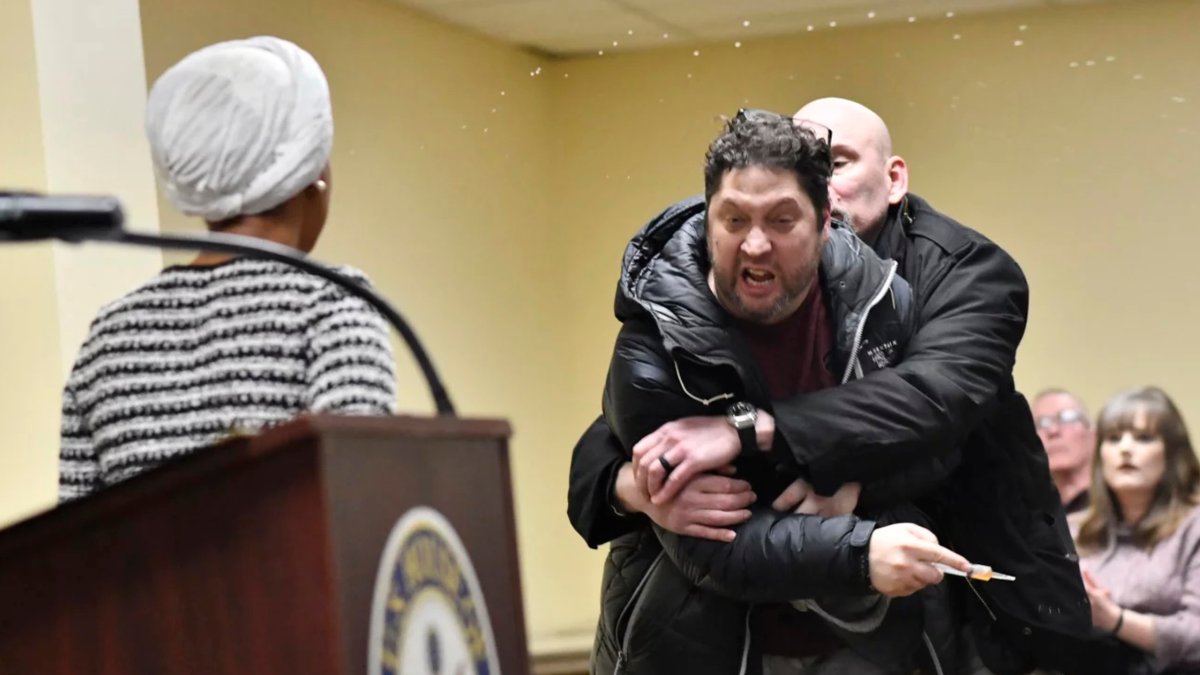 Rep. Ilhan Omar rushed by man on stage and sprayed with liquid at town hall event