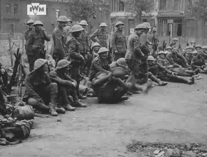 Men of the New Zealand Division participate in an impromptu triple-jump contest during a rest in a village square on the Western Front, 1916. Film: IWM 138
