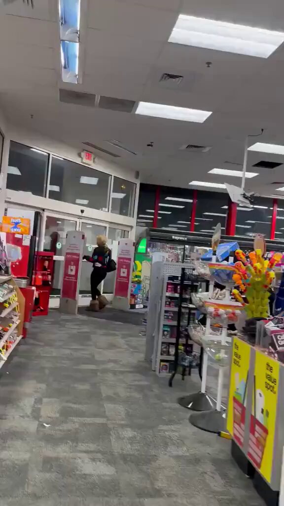A group of black women stealing items from a store laughing without shame and saying, “Open these doors. As the employee attempts to take the items back, she says, “Don’t touch me or I will call my kids.