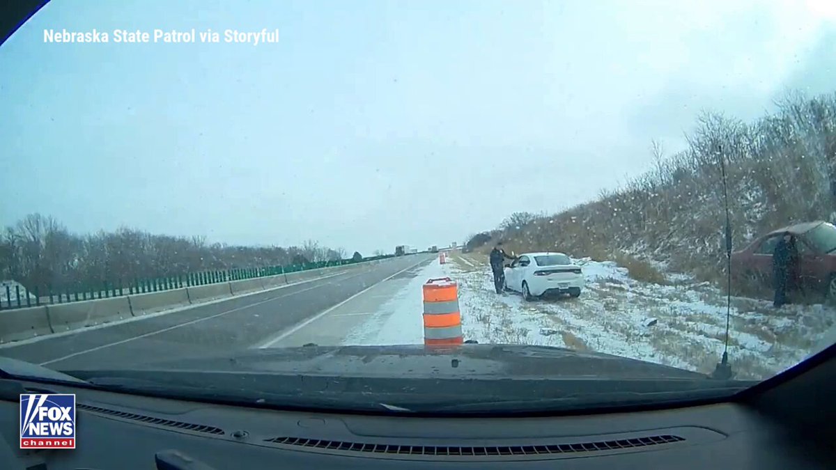 CLOSE CALL: Nebraska state troopers narrowly avoided disaster after an out-of-control car slid off a slick stretch of Interstate 80, crashing into a vehicle they were helping on the roadside. Dashcam video shows the moment troopers jumped clear as authorities warned even light snow can create deadly driving conditions and cause sudden slide-offs.