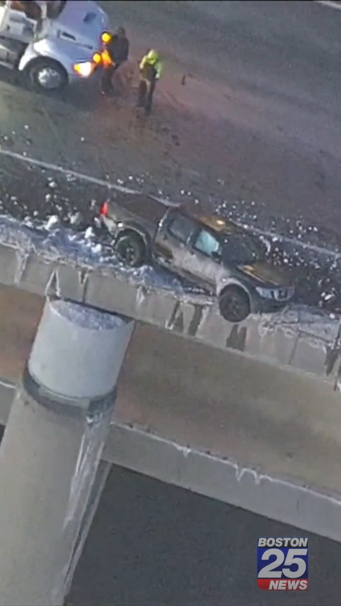 SCARY WRECK: Aerial video shows a pickup truck perched on a snowbank in a precarious position, hanging over a concrete wall on the deck of the Zakim Bridge.