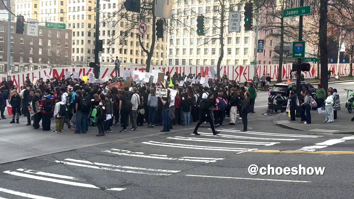 Thank God Seattle Police officers were trailing these high school students all day. It was for their own good as crowds blocked traffic. Btw, lots of foreign flags being carried today.