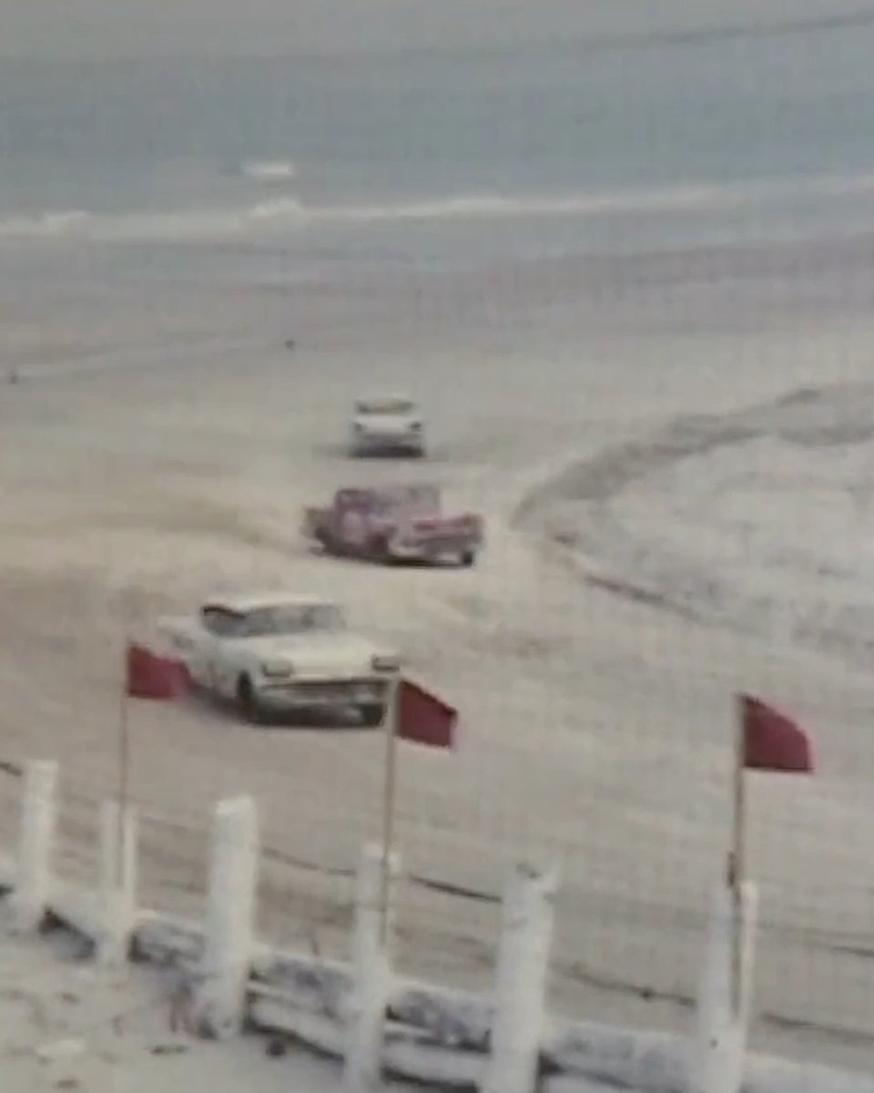 Where American muscle meets sunlit sand. NASCAR racing on Daytona Beach in the 1950s.